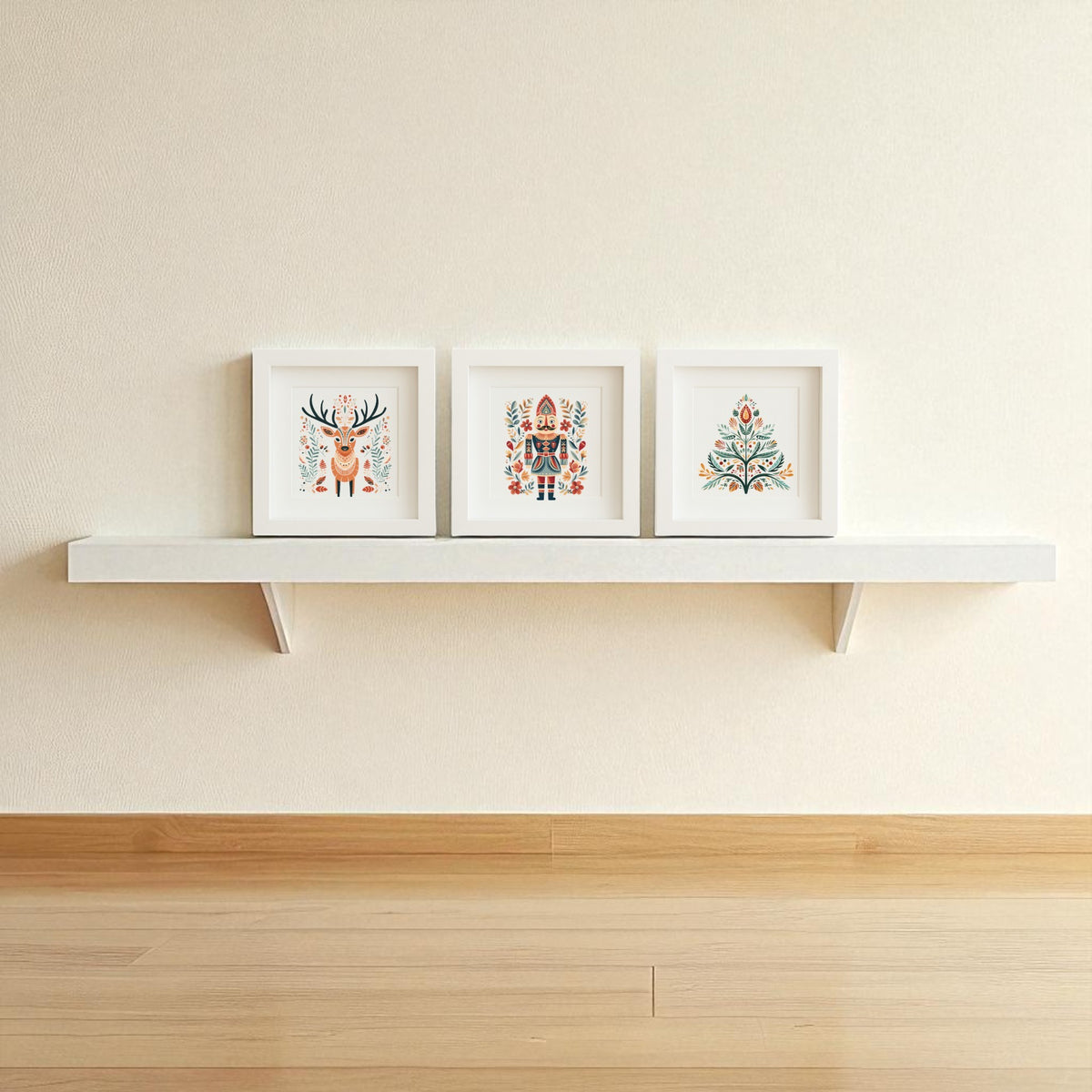 The Reindeer Nutcracker Tree Shadowbox Trio by Mirabilia Boutique brings Scandinavian holiday charm to your space, with three framed illustrations as festive wall art above a light wood floor and beige wall.