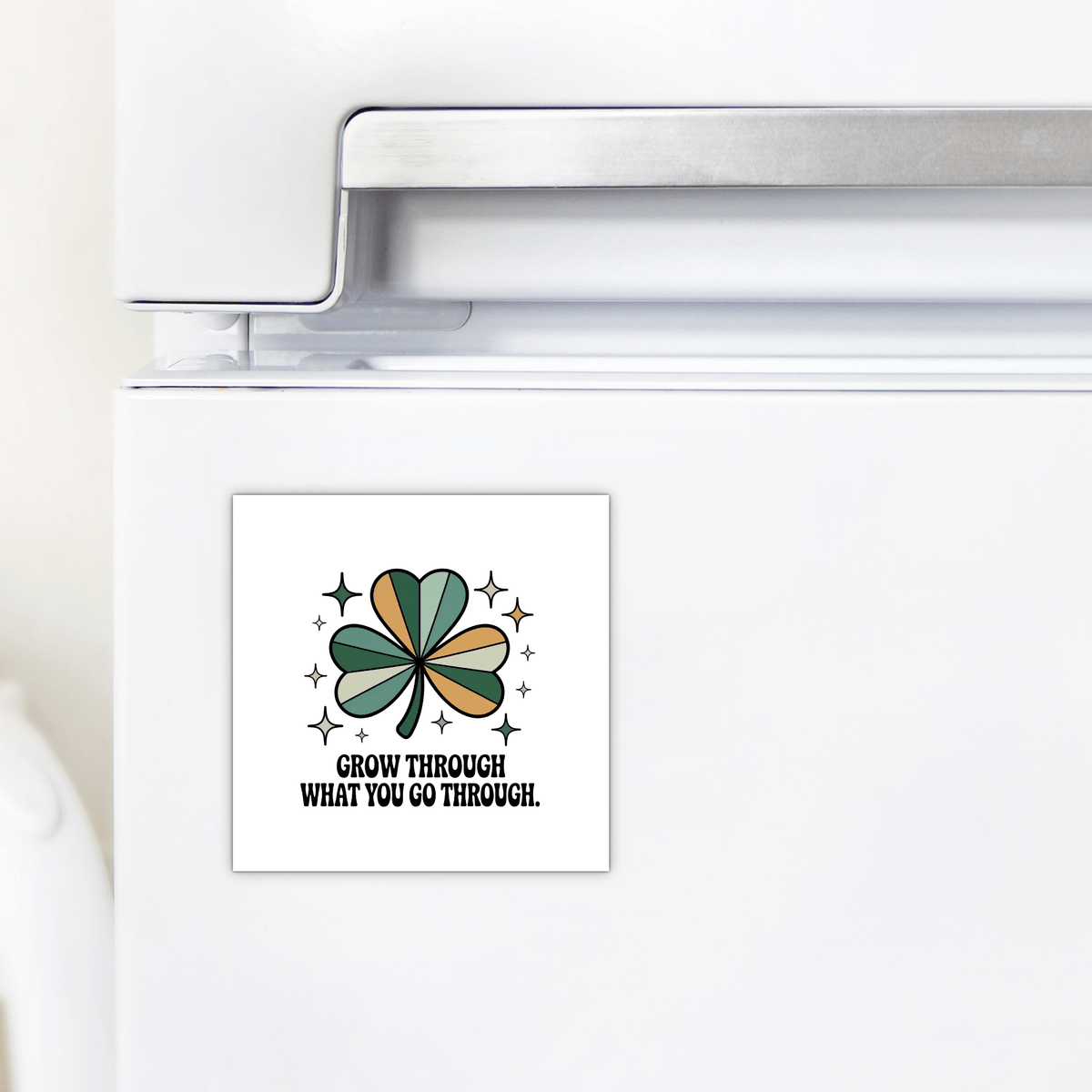 The Mirabilia Boutique "Grow Through What You Go Through" Magnet is a square fridge magnet with a green shamrock, stars, and an inspiring message—ideal for daily motivation and resilience.