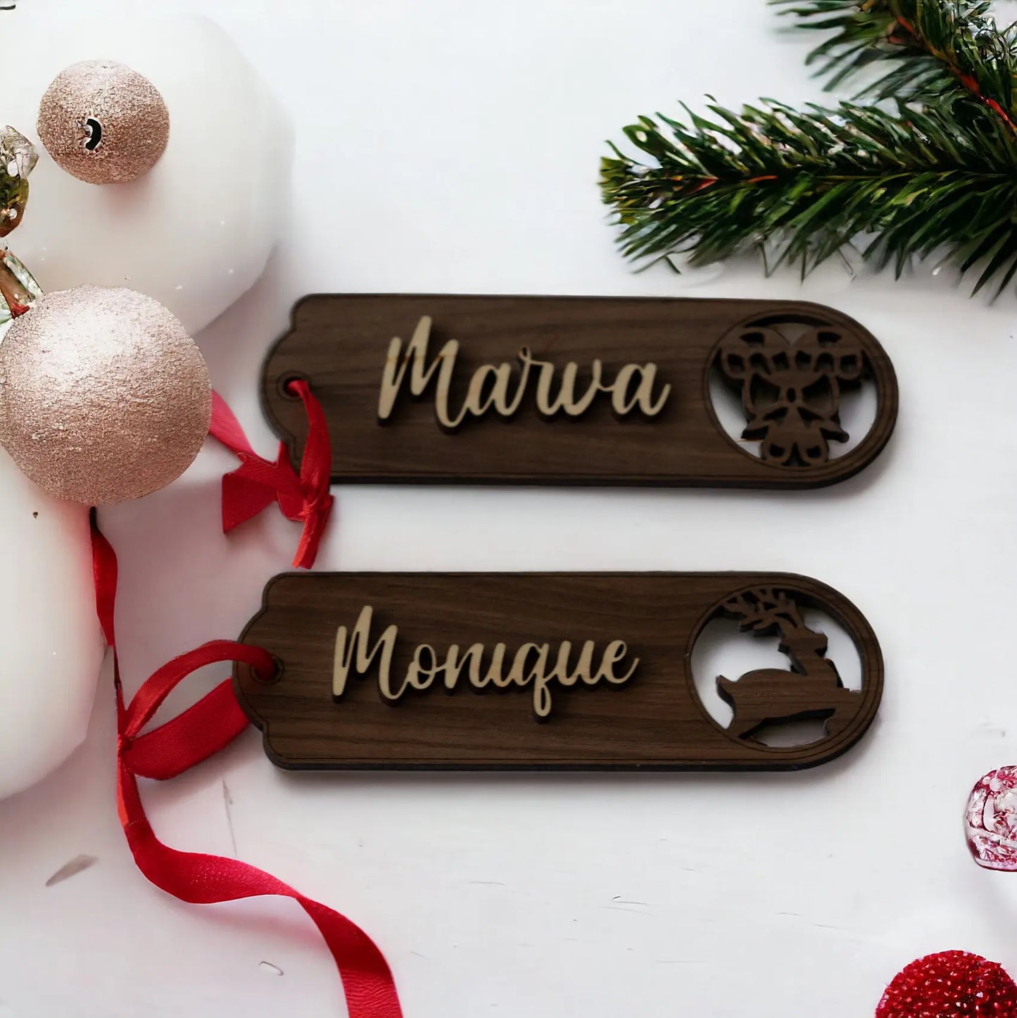 Two Personalized Wooden Stocking Tags by Mirabilia Boutique—custom laser-cut with names and festive designs—add a unique touch to your holiday décor. Each Mirabilia Boutique keepsake makes a charming Christmas ornament or gift tag.