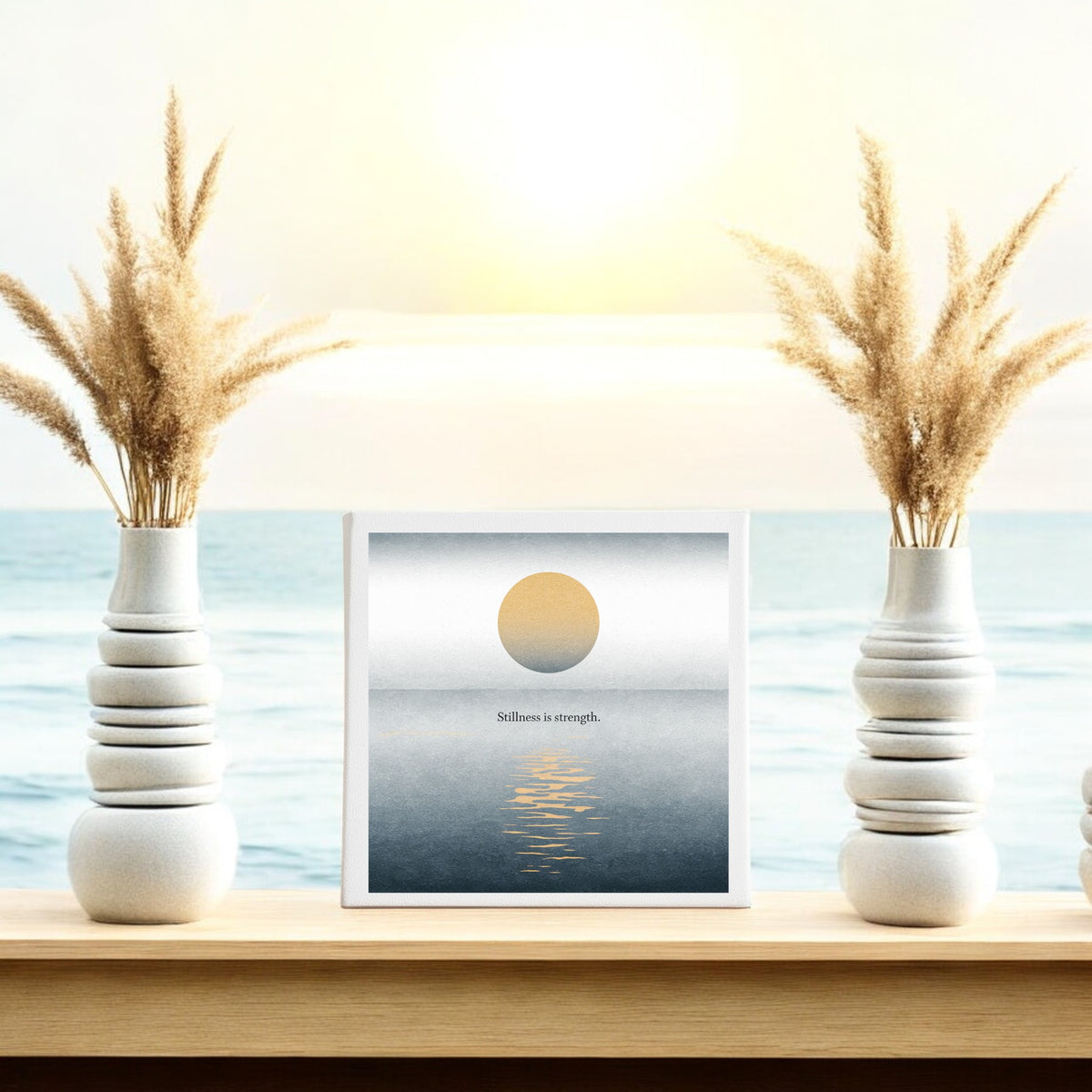 The Stillness Is Strength Canvas by Mirabilia Boutique features minimalist sun and ocean art with "Stillness is strength," making it perfect meditation decor for a serene, calming space.