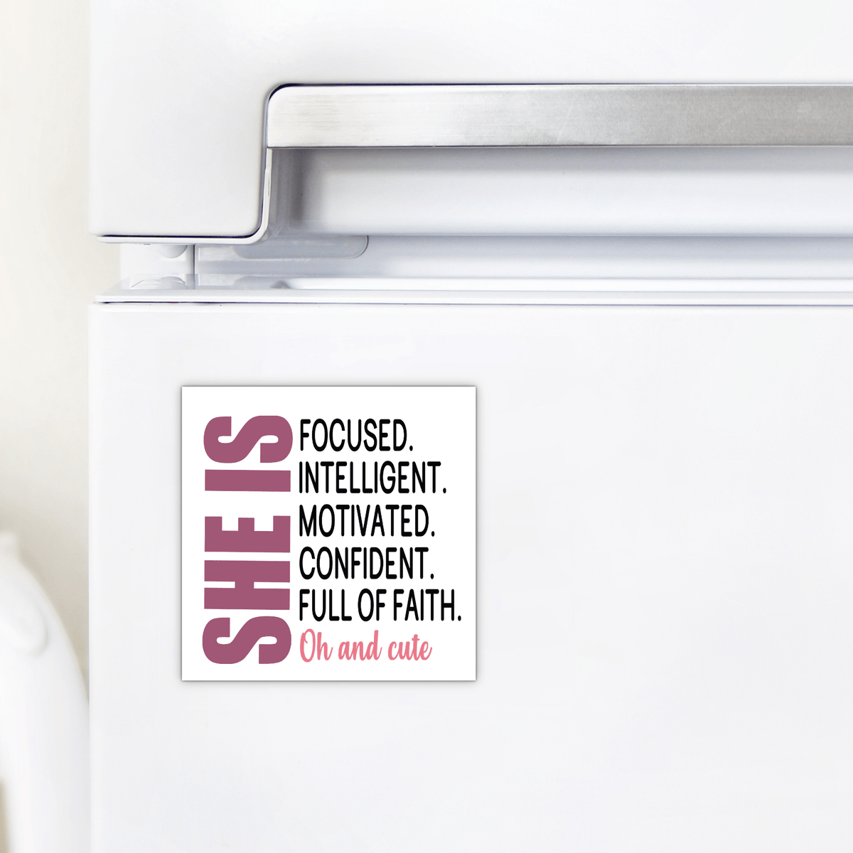 The She Is Motivated & Confident Magnet by Mirabilia Boutique features a black and pink quote: "SHE IS FOCUSED. INTELLIGENT. MOTIVATED. CONFIDENT. FULL OF FAITH. Oh and cute"—an inspiring gift for her.