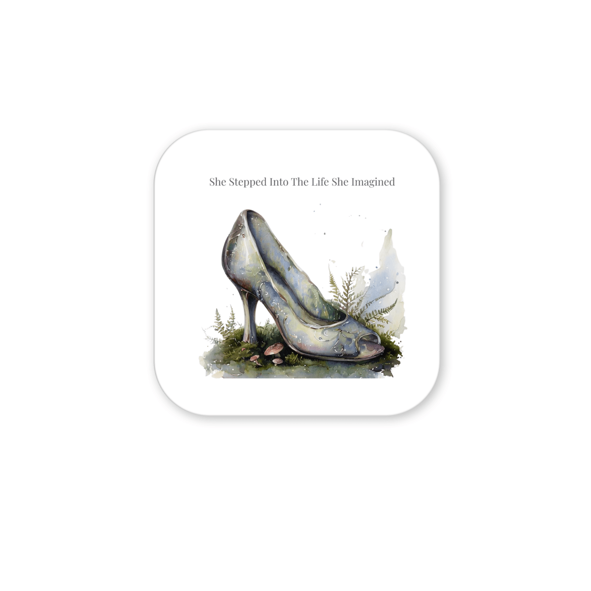 A watercolor glass slipper rests amid grass, moss, and nearby ferns, setting a fairytale scene. Above it, the words "She Stepped Into the Life She Imagined" add inspiration to this Mirabilia Boutique creation. The She Stepped Into the Life She Imagined Magnet is a truly uplifting refrigerator magnet for dreamers and believers alike.