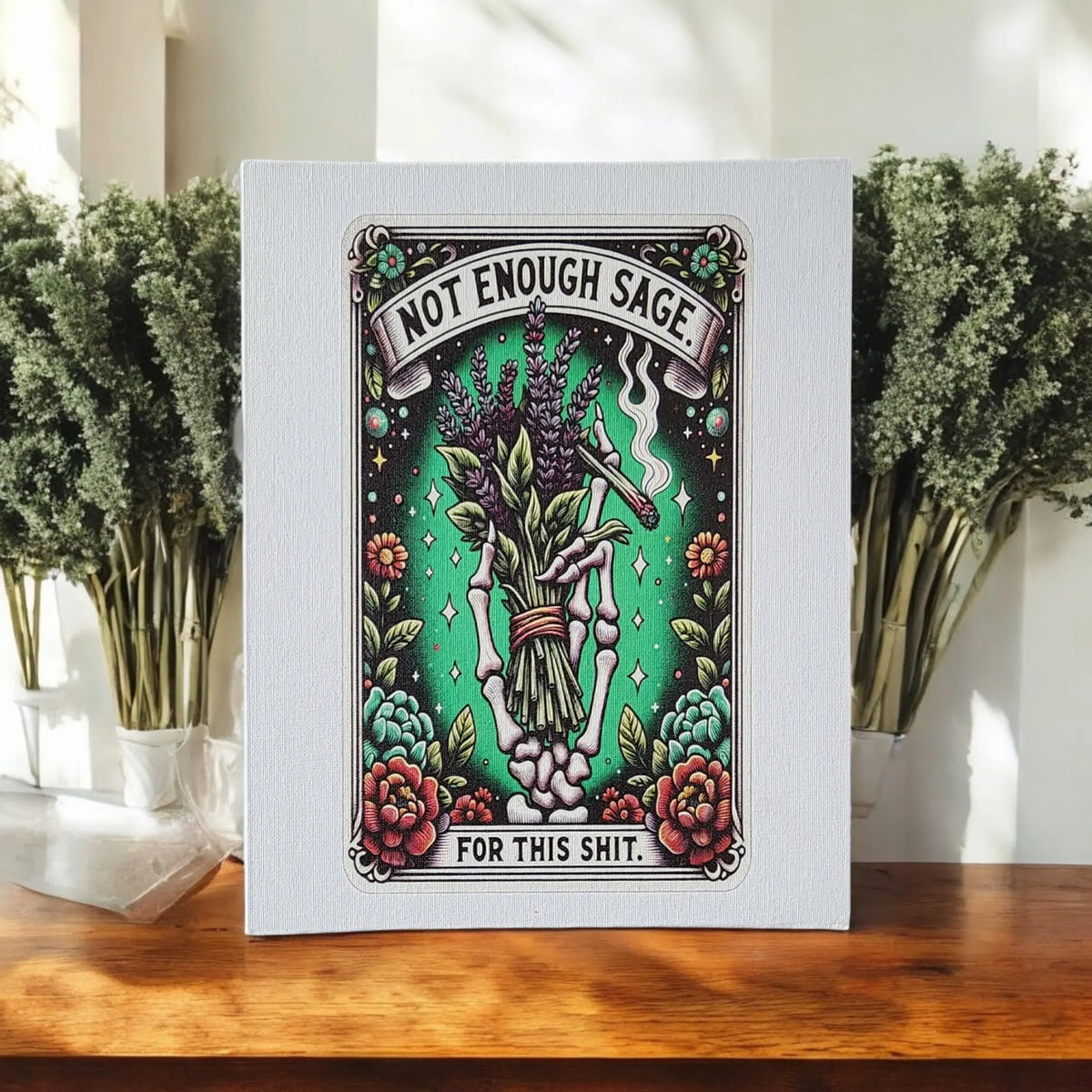 Mirabilia Boutique’s 8x10 “Not Enough Sage” Canvas Print features a vintage tattoo-style skeleton hand with sage and flowers, plus sarcastic text—perfect witchy wall art or spiritual decor for your home.