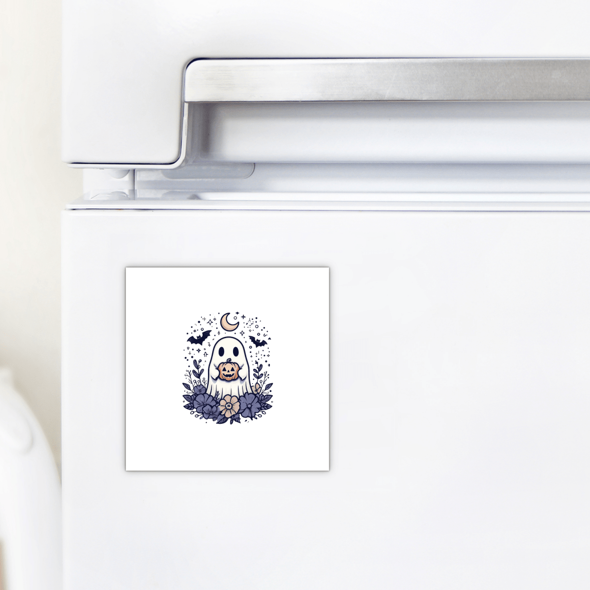 A magnet from Mirabilia Boutique's "Cute Ghost Pumpkin Magnet | Whimsical Halloween Decor" collection features an adorable dog dressed as a ghost, surrounded by autumn leaves with a crescent moon and bats in the background—making it the perfect seasonal decoration for your refrigerator.