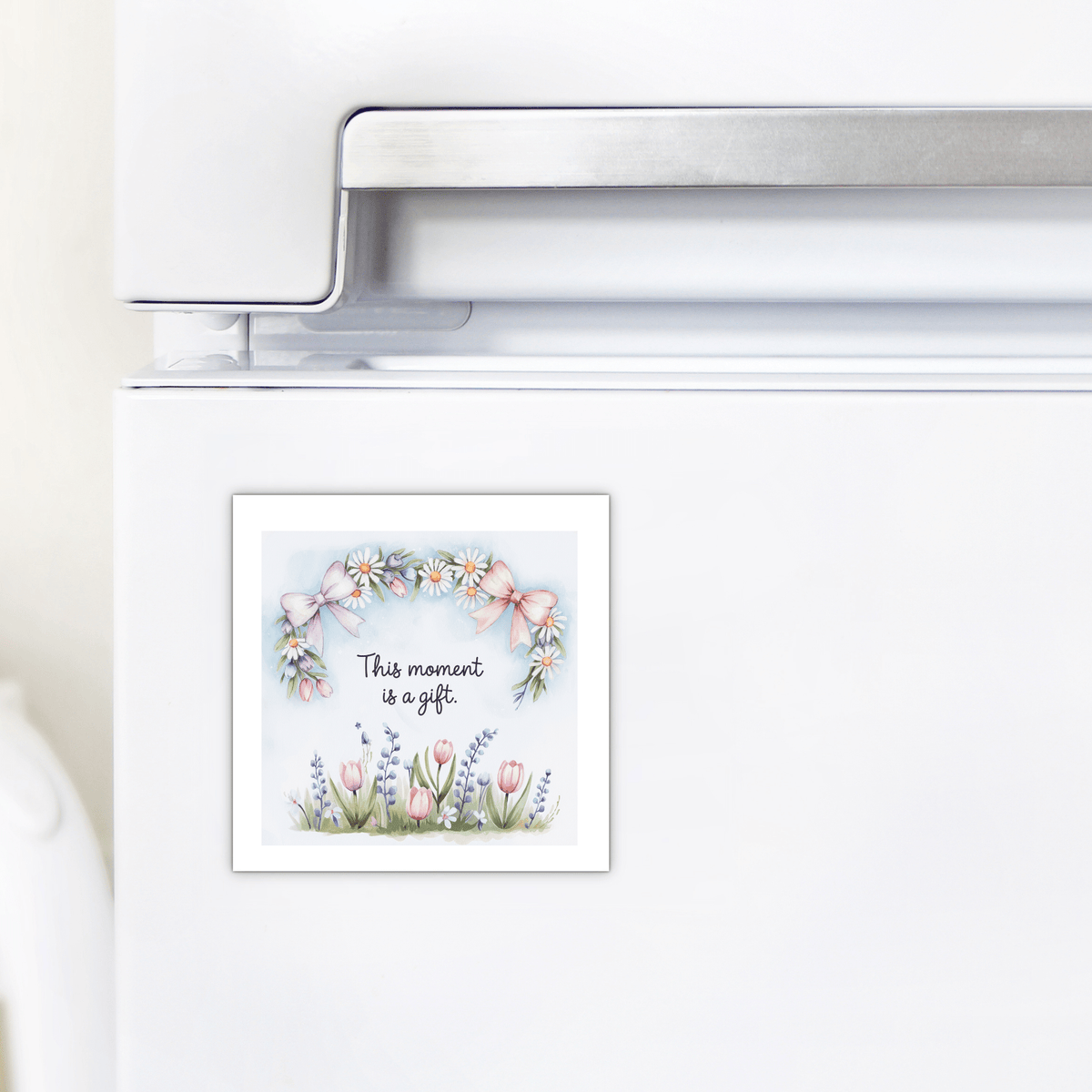 The Mirabilia Boutique “This Moment Is a Gift Magnet – Floral Spring Quote” features pastel daisies, tulips, lavender, and pink bows—an inspirational mindfulness gift for any home fridge.