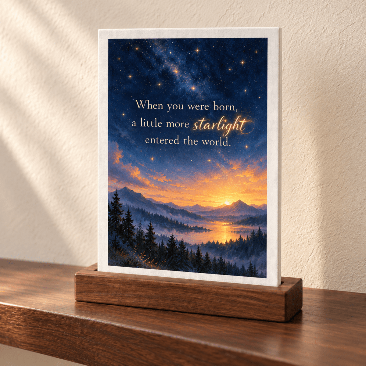A Little More Starlight Friendship Mini Sign, featuring a rectangular print of a starry night sky over mountains and a lake with the text, “When you were born, a little more starlight entered the world,” displayed in a wooden stand.