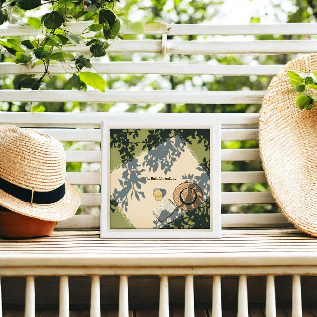 The Light Felt Endless Canvas – Summer Stillness Art by Mirabilia Boutique sits on a slatted outdoor bench with two straw hats. Sunlight through leafy branches casts dappled shadows, embodying slow living in this artful scene.