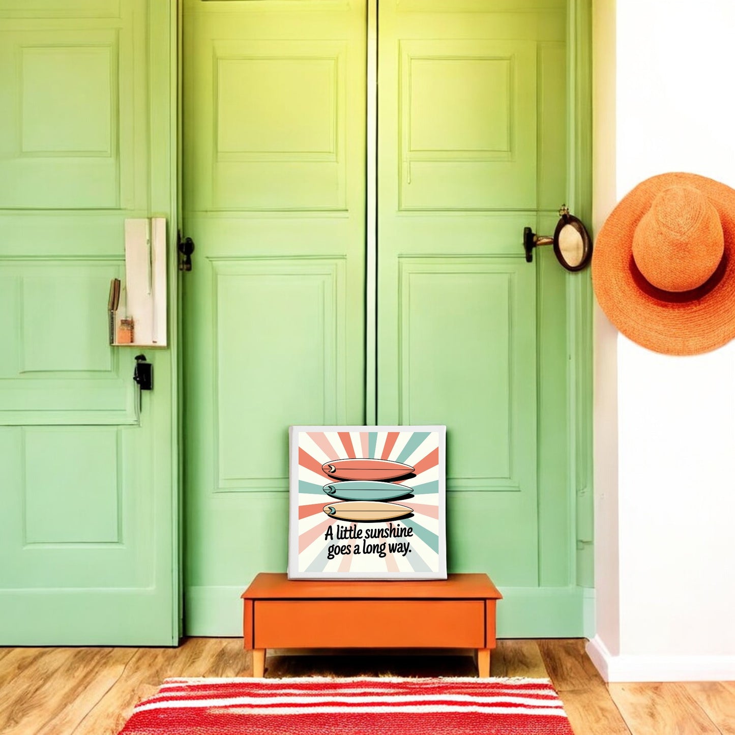 A mint green double door with a round mirror and orange sun hat hang on the wall. An orange bench holds the "A Little Sunshine Canvas – Retro Surf Summer Vibes" by Mirabilia Boutique, perfect for sunshine wall decor lovers.