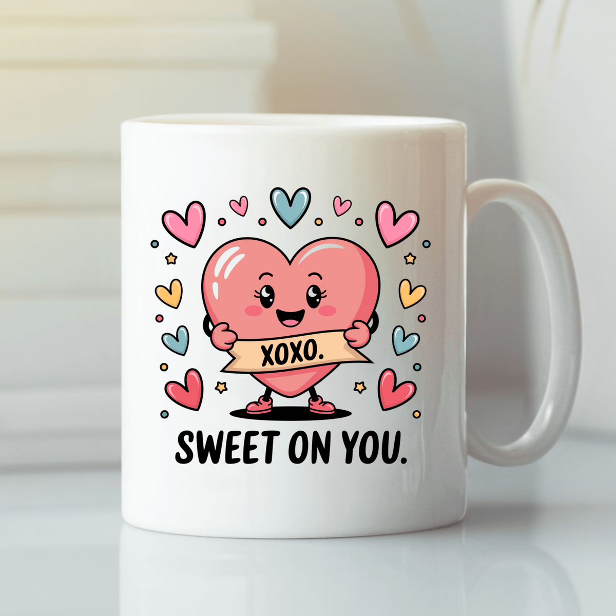 The Sweet On You Heart Mug by Mirabilia Boutique features a cute pink heart with an "XOXO" banner, surrounded by colorful hearts and stars, plus "SWEET ON YOU" text—making it the perfect cute Valentine’s gift for someone special.