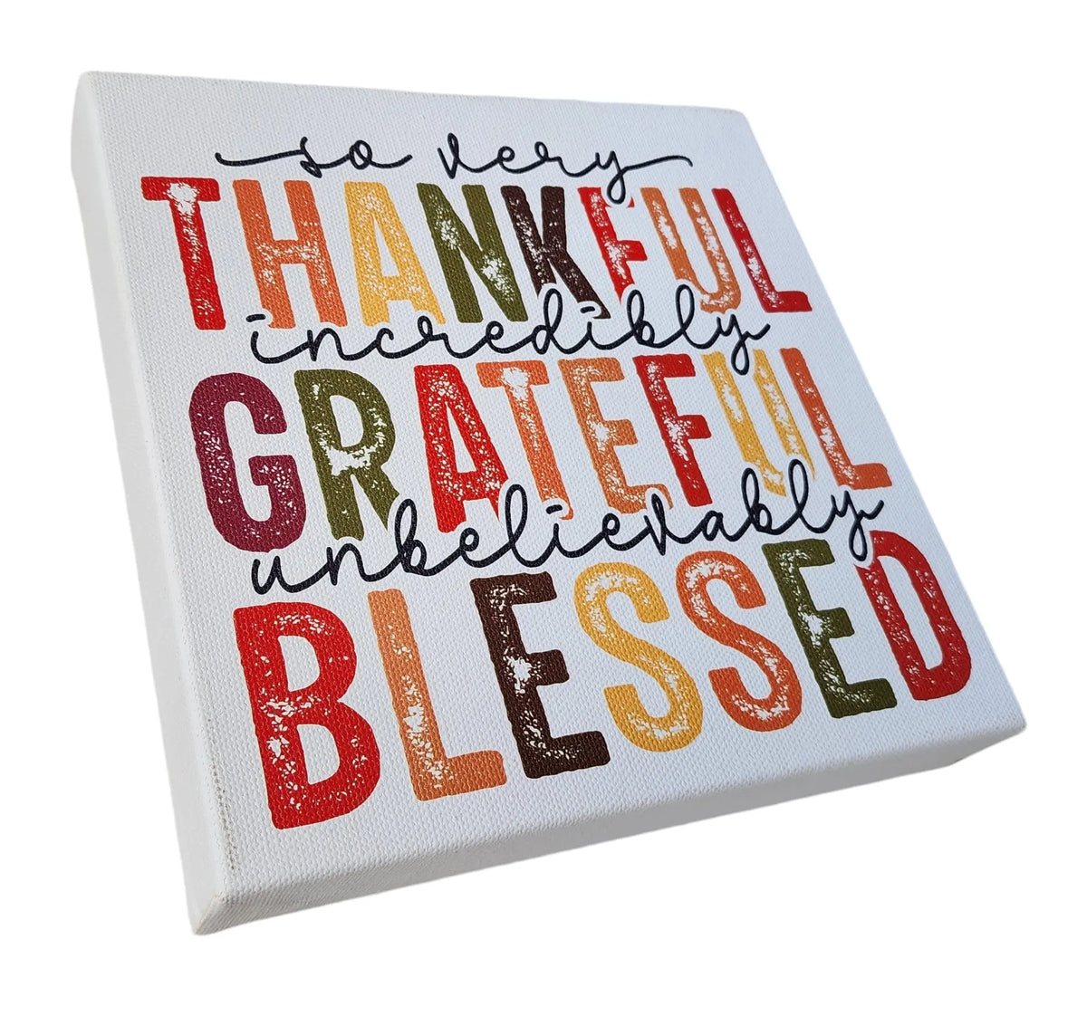 Mirabilia Boutique's Thankful Grateful Blessed Inspirational Sign for Seasonal Home Decor is a square canvas piece featuring colorful words in various fonts. The text reads, "So very thankful, incredibly grateful, unbelievably blessed," arranged in multiple lines and predominantly showcasing Thanksgiving colors of red, orange, yellow, green, and brown. This decor is perfect for adding a touch of gratitude to your home.