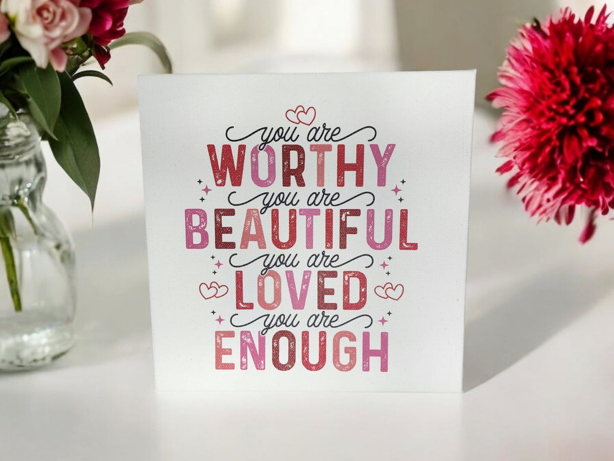 The Mirabilia Boutique "You Are Worthy" Affirmation Sign is an 8x8 inspirational canvas wall art for women or teens, featuring pink flowers and uplifting messages—a perfect positive decor or self-love gift.