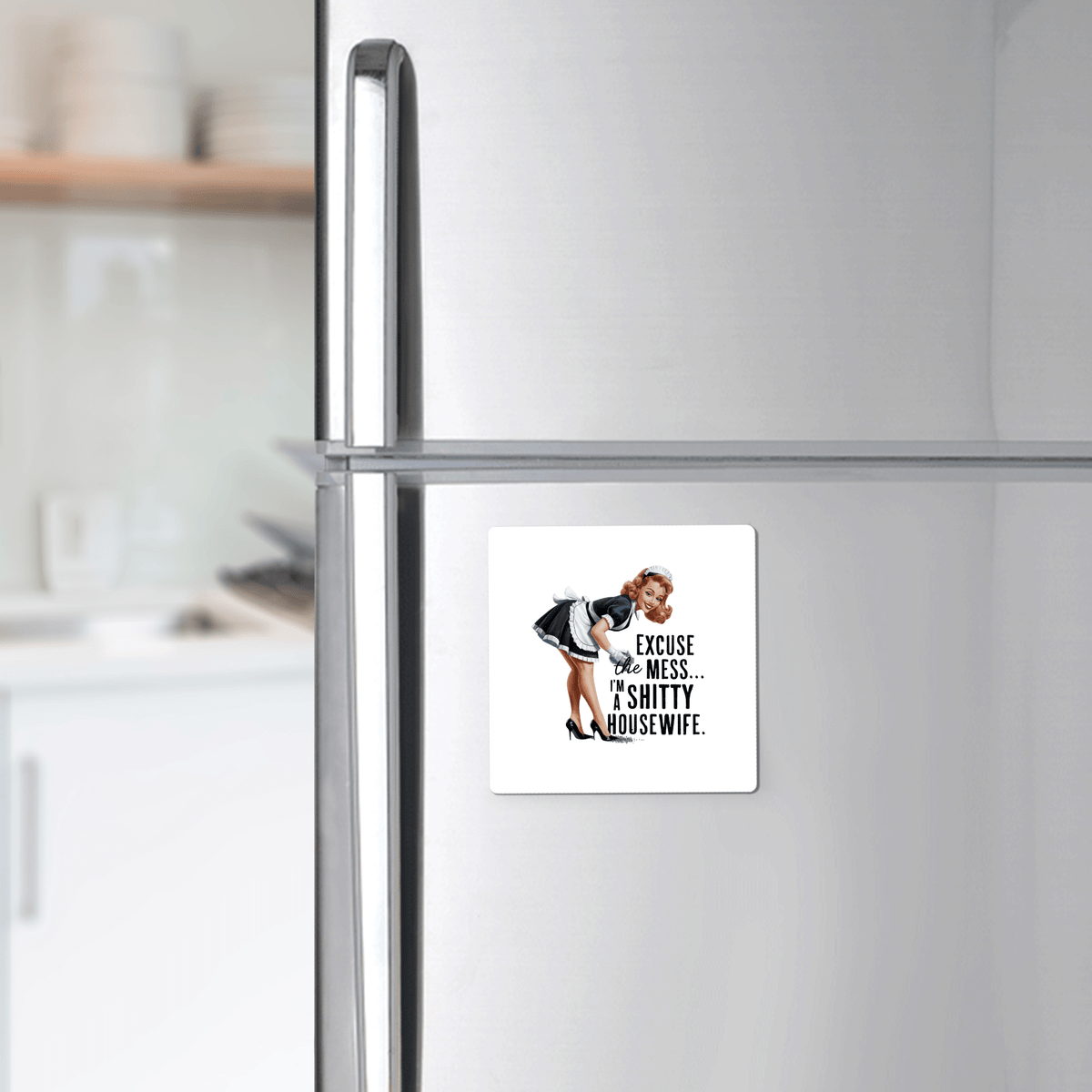 The Mirabilia Boutique “Excuse the Mess” Magnet is a 3x3 UV-printed retro fridge magnet featuring a cheeky apron-clad woman and the text: “I’m a Sh*tty Housewife”—a funny, sarcastic gift for your kitchen décor.