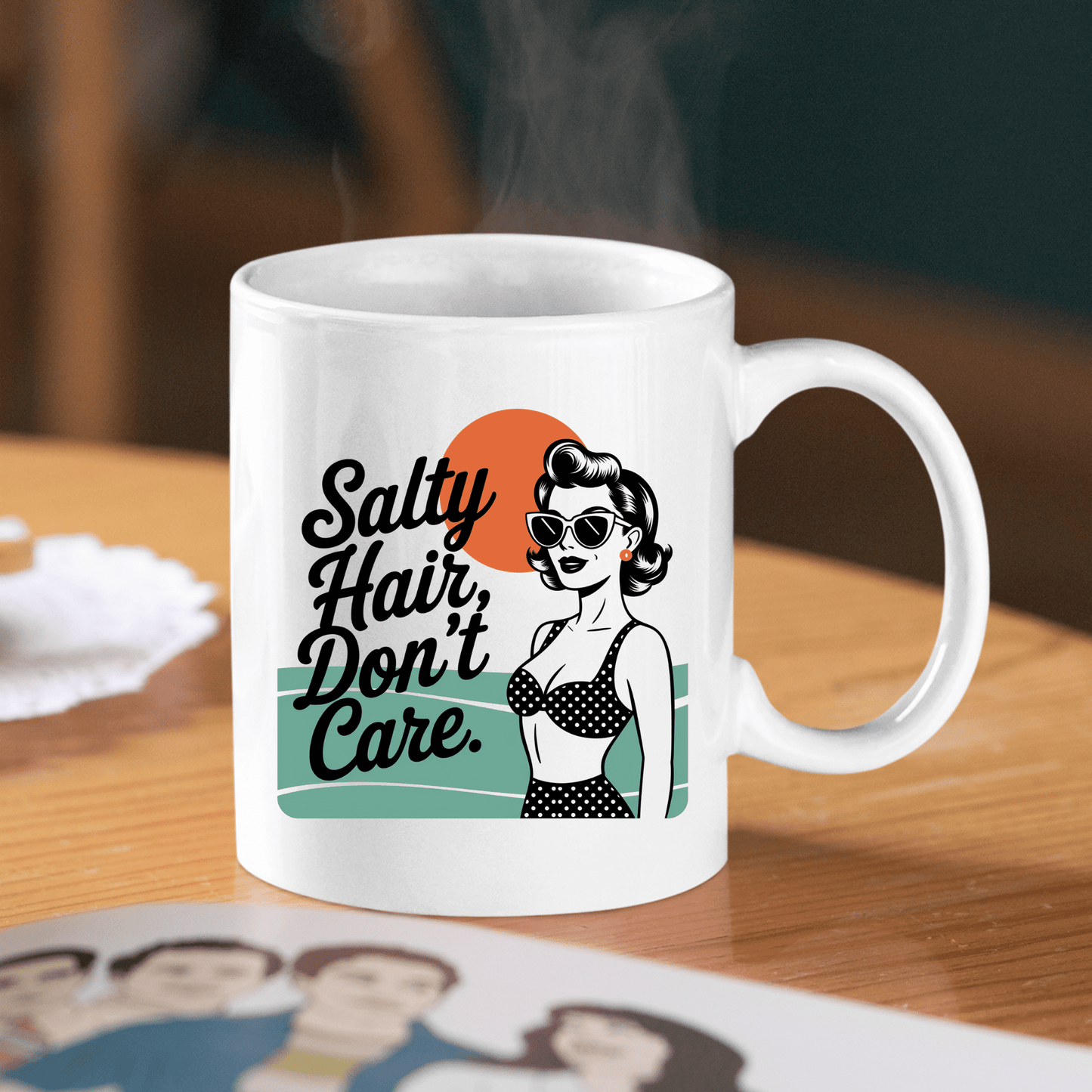 The Mirabilia Boutique Salty Hair Don’t Care Mug features a retro beach babe in sunglasses and a polka-dot bikini before an orange sun, with “Salty Hair, Don’t Care” for playful coastal vibes.