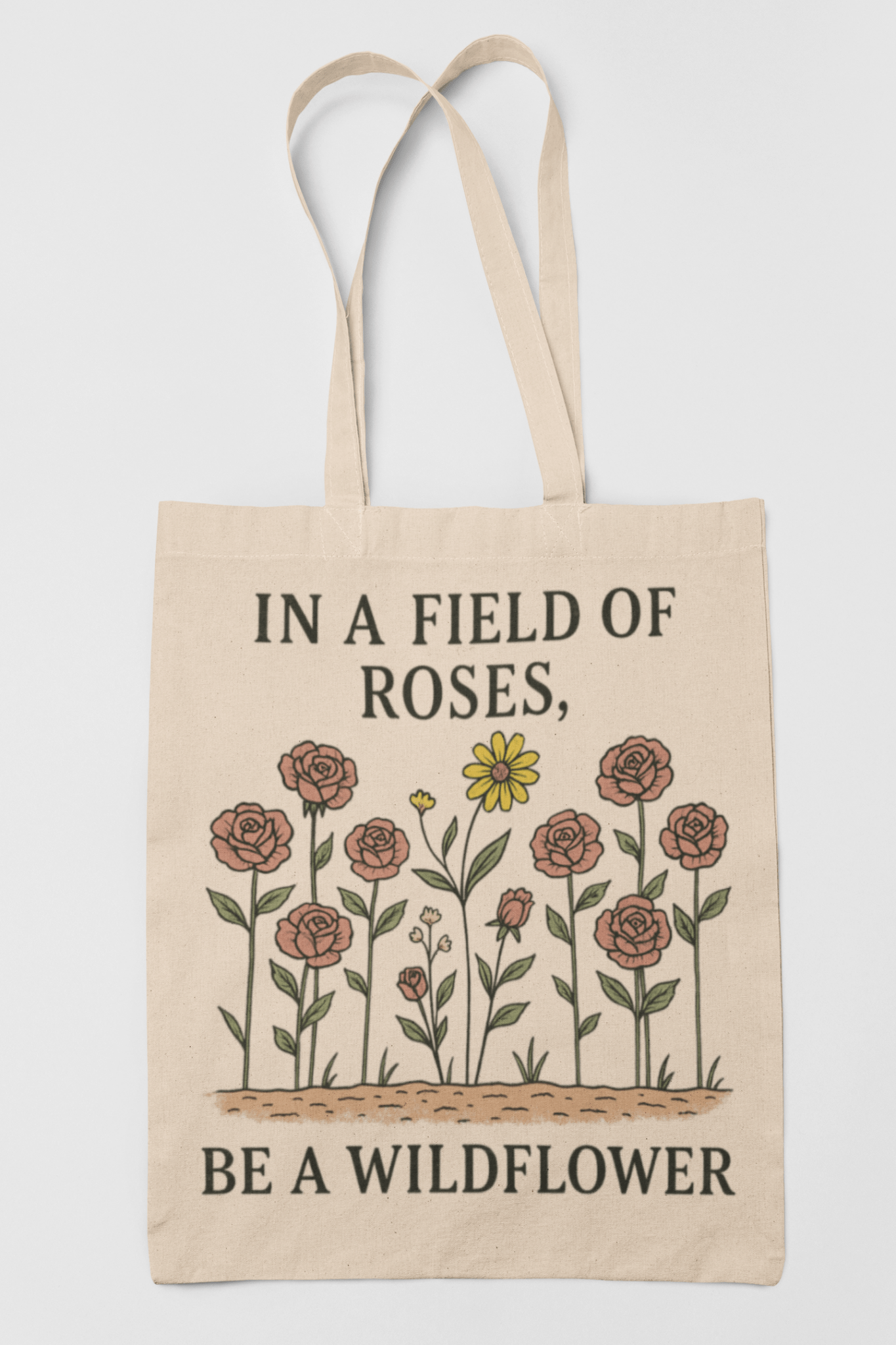 The "Be a Wildflower Tote Bag" by Mirabilia Boutique is an eco-friendly beige canvas bag with six red roses, one yellow wildflower, and the text: "In a field of roses, be a wildflower.
