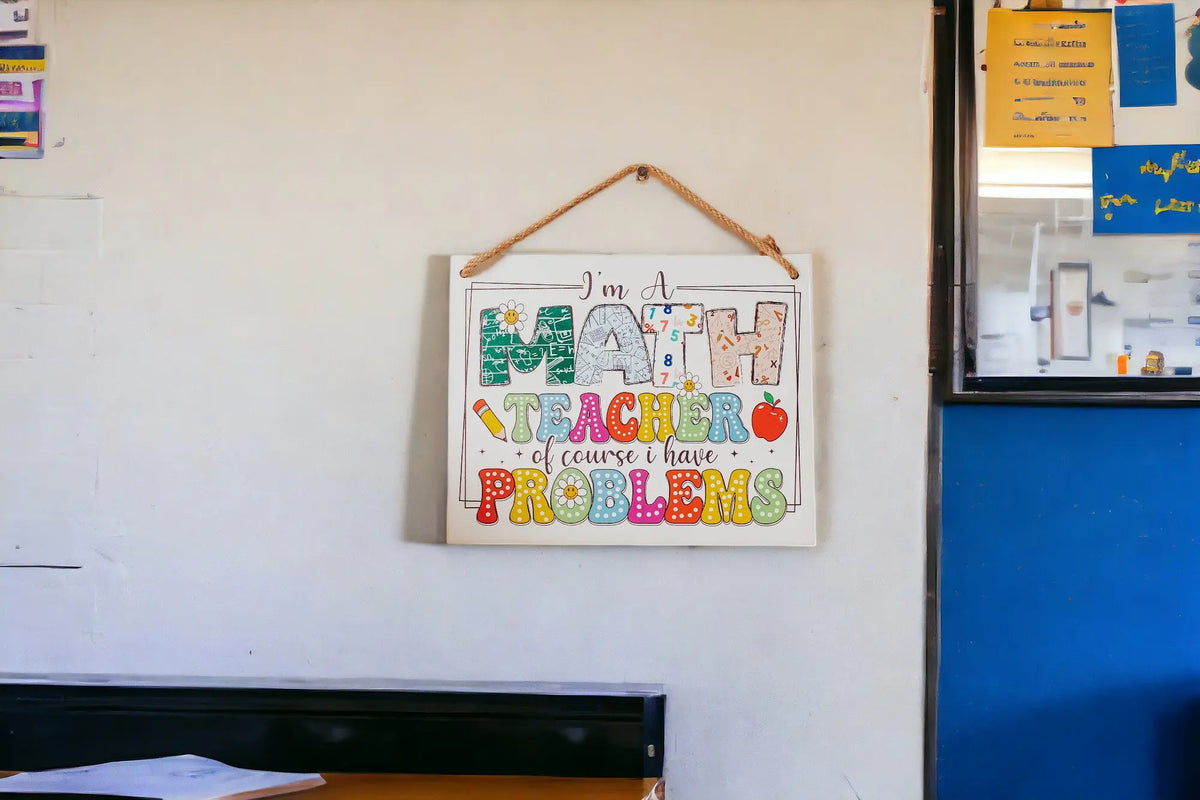 The Mirabilia Boutique Funny Math Teacher Classroom Sign features "I'm A Math Teacher Of Course I Have Problems" in colorful, math-themed decor—an ideal teacher appreciation gift for doors or walls.