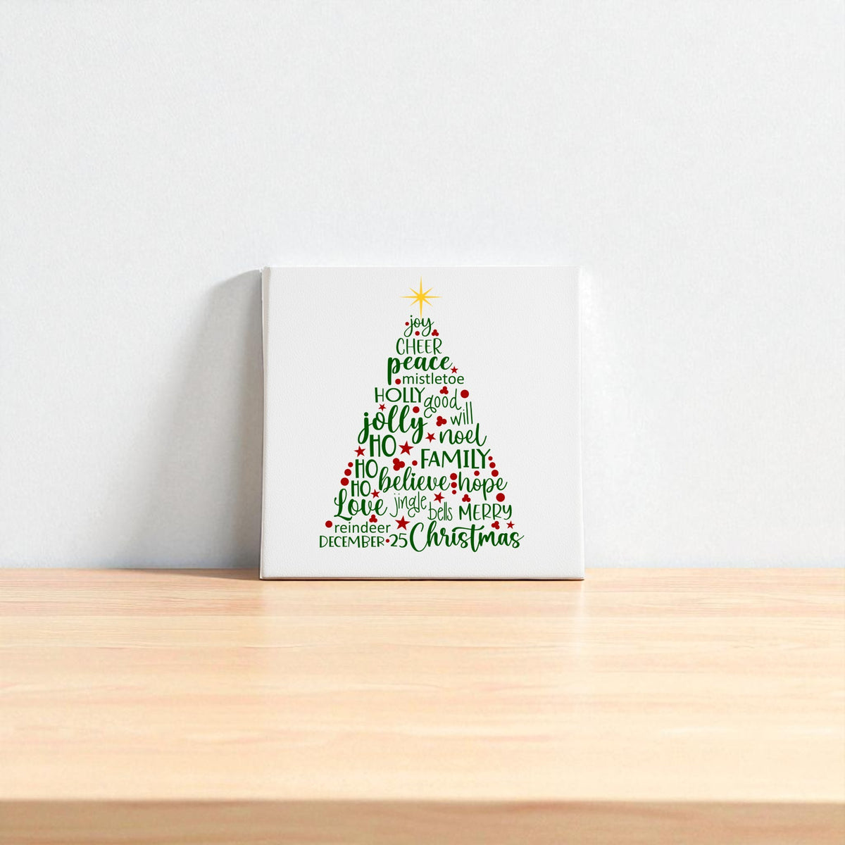 The Word Art Christmas Tree Canvas by Mirabilia Boutique features festive words in red and green forming a tree with a yellow star, adding holiday charm to your space. Available as 8x8 holiday decor, it's perfect for brightening up any room.