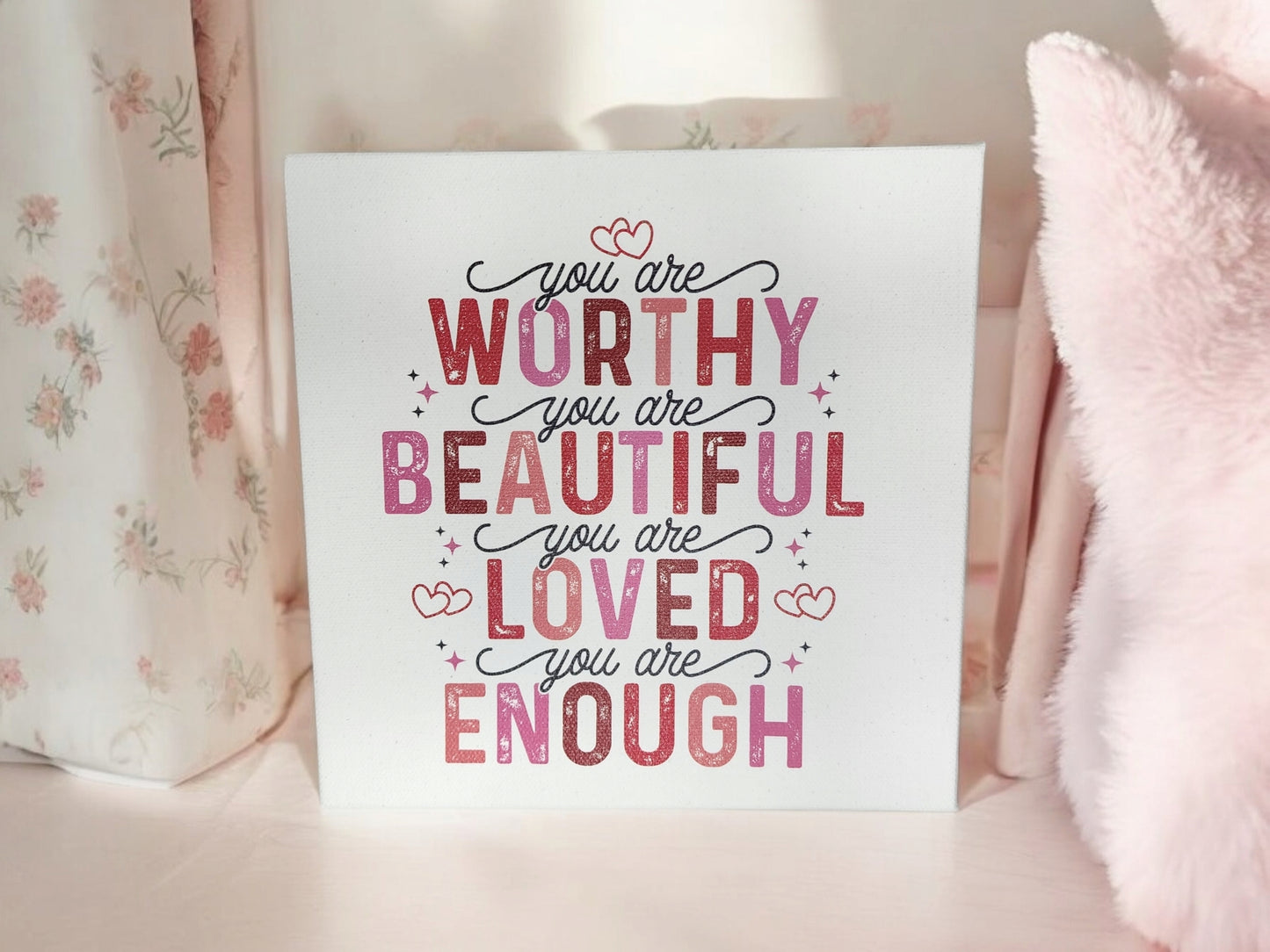 The Mirabilia Boutique "You Are Worthy Affirmation Sign" is an 8x8 canvas wall art with pink and red text and heart accents, reading “You are worthy, you are beautiful, you are loved, you are enough”—perfect inspirational decor for women or teens.