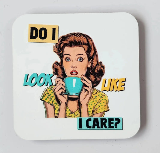 The Do I Look Like I Care Funny Refrigerator Magnet by Mirabilia Boutique features a vintage-style illustration of a woman with wavy brown hair, dressed in a yellow polka-dot dress, holding a teal mug close to her face. The text surrounding her reads, "DO I LOOK LIKE I CARE?" in bold black, yellow, and teal lettering. This whimsical magnet is sure to be both a conversation starter and charming kitchen decor.