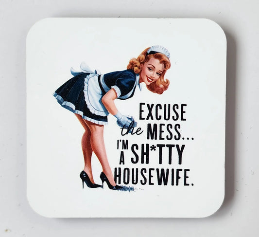 The "Retro 'Excuse the Mess' Shitty Housewife Magnet" by Mirabilia Boutique features a vintage-style illustration of a smiling housewife in a black and white maid outfit and high heels, leaning forward. The accompanying text humorously states, "Excuse the mess... I'm a sh*tty housewife," making it an ideal quirky addition to your kitchen decor.