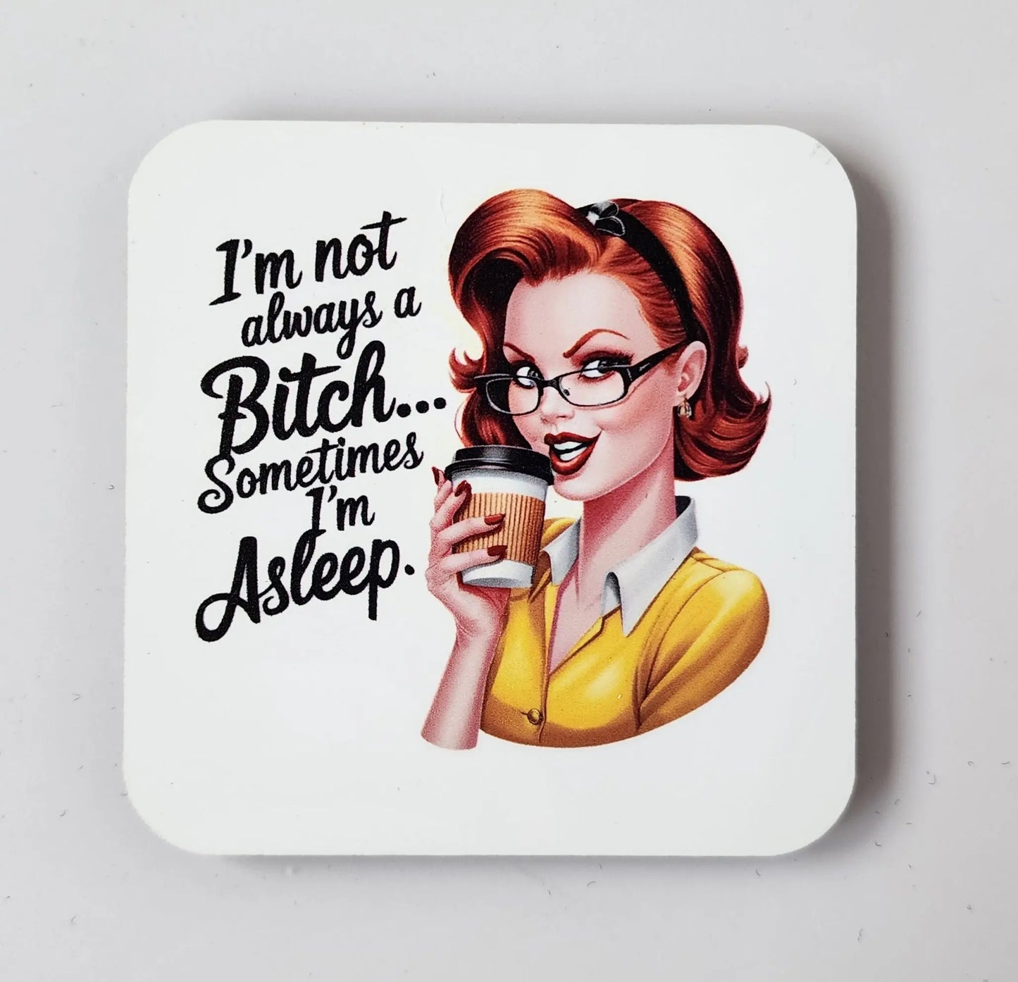 Consider the Snarky "I'm Not Always a Bitch, Sometimes I'm Asleep" Magnet by Mirabilia Boutique. This quirky gift showcases a retro-style illustration of a sassy red-haired woman with glasses, donning a yellow sweater over a white shirt while holding a coffee cup. It's perfect for adding some snark to your fridge!
