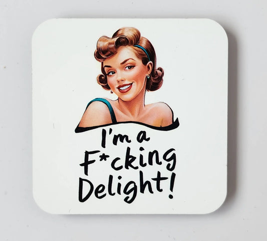 The "I'm a Fucking Delight" snarky magnet from Mirabilia Boutique showcases a smiling woman with a vintage hairstyle and makeup. The playful, bold handwriting below her reads, "I'm a F*cking Delight!" against an entirely white background.
