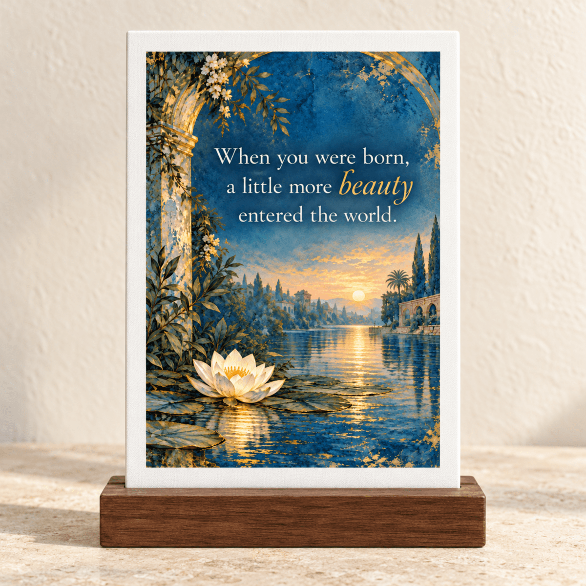 A Little More Beauty Friendship Mini Sign featuring a rectangular plaque on a wooden base with a water lily on a lake at sunset and the text: “When you were born, a little more beauty entered the world.”