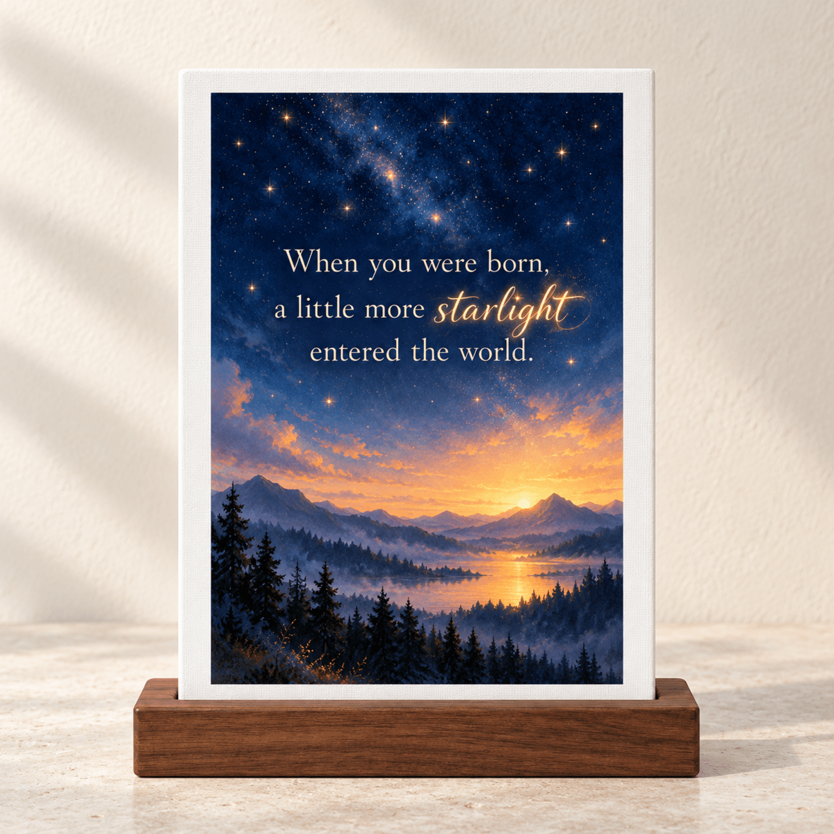 A Little More Starlight Friendship Mini Sign featuring a canvas-panel in a wooden stand with a sunset over mountains and a forest, inscribed with, “When you were born, a little more starlight entered the world.”