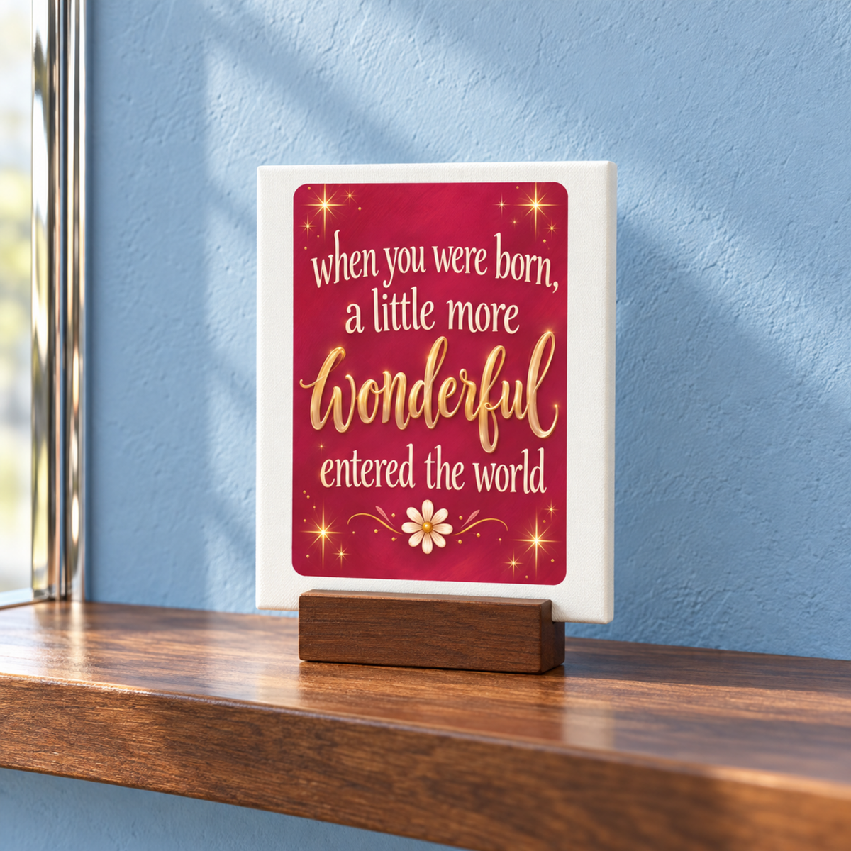 A When You Were Born Friendship Mini Sign | Chrome & Starlight rectangular sign on a wooden stand reading, “When you were born, a little more wonderful entered the world,” with stars and a flower on a dark red background.