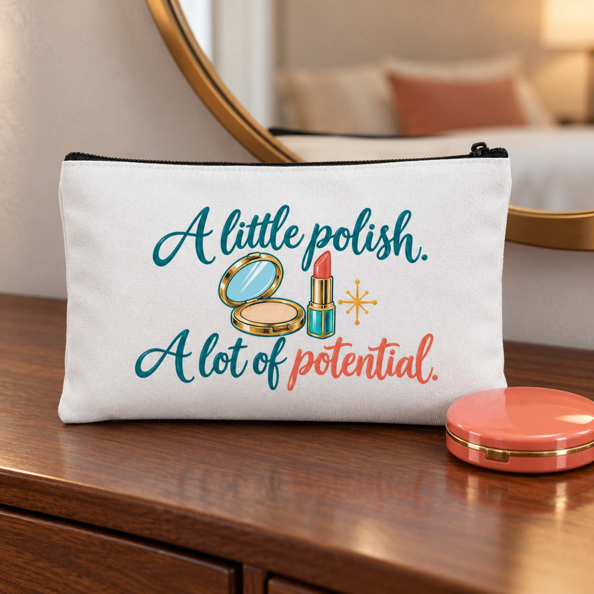The A Little Polish, A Lot of Potential Makeup Bag by Mirabilia Boutique rests on a wooden dresser, featuring its signature quote and playful compact mirror and lipstick illustrations.