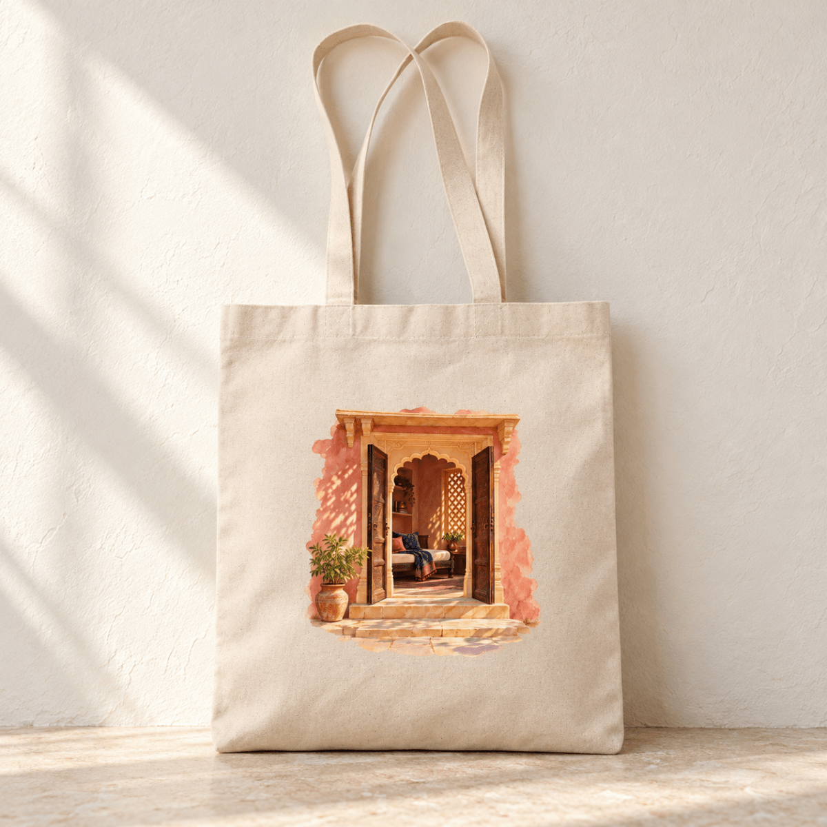 A Place to Return Tote Bag by Mirabilia Boutique, featuring a watercolor illustration of an open, arched wooden doorway leading to a sunlit patio on a natural canvas bag.