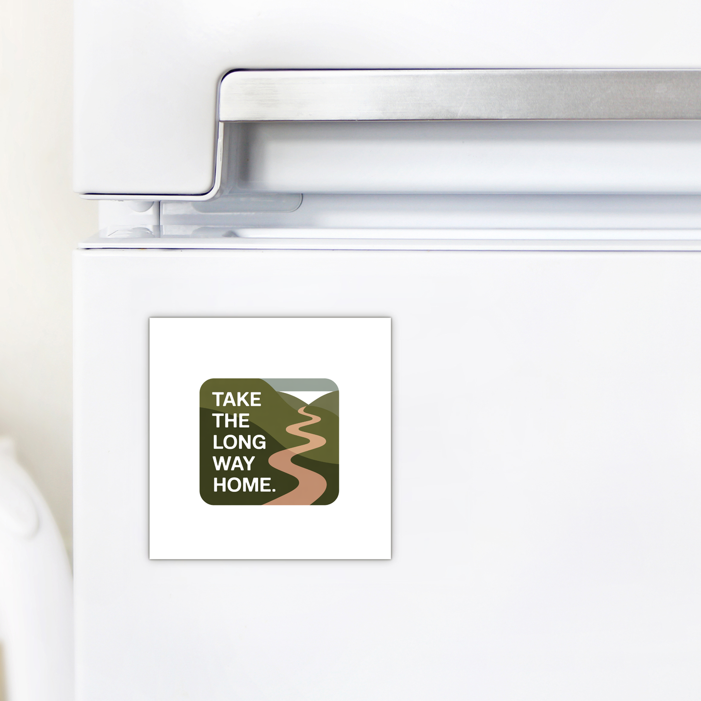 The Mirabilia Boutique Take the Long Way Home Travel Magnet is a square, nature-inspired accent featuring a winding road through green hills and the quote "TAKE THE LONG WAY HOME"—perfect for decorating your fridge.