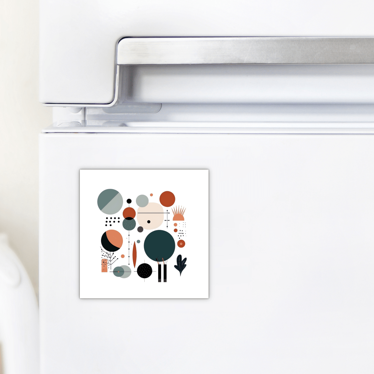 The Harvest Sun Mid Century Modern Magnet by Mirabilia Boutique, featuring abstract geometric shapes in muted tones, is displayed on a white fridge near the freezer handle, bringing warm fall style to your kitchen decor.