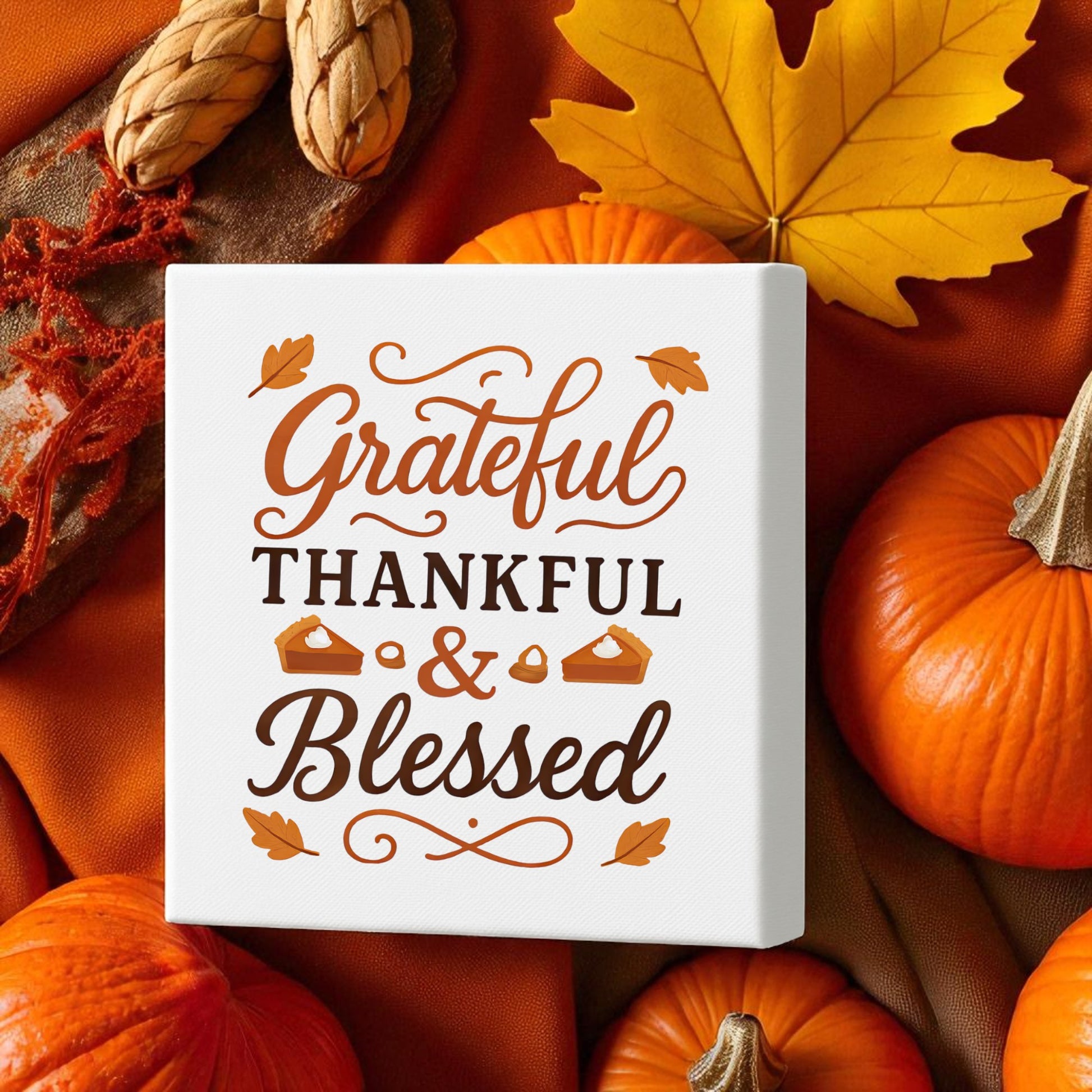The Grateful Thankful Blessed Canvas (8x8) from Mirabilia Boutique features autumn pumpkins, leaves, and acorns—perfect fall wall art for warming up your space and celebrating Thanksgiving.