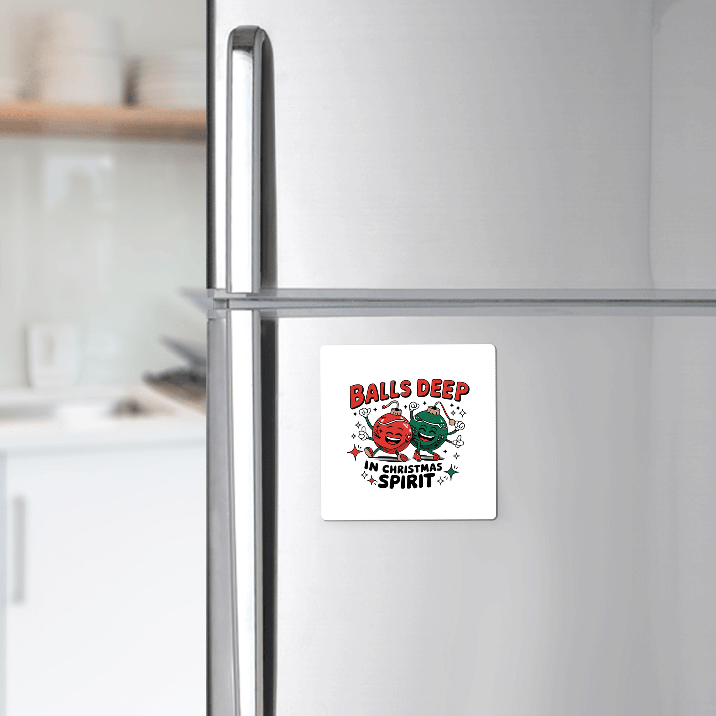 Add festive humor to your fridge with the Funny Christmas Magnet | Balls Deep in Holiday Spirit by Mirabilia Boutique, featuring two ornament faces and bold red and black text: “Balls Deep in Christmas Spirit.”.