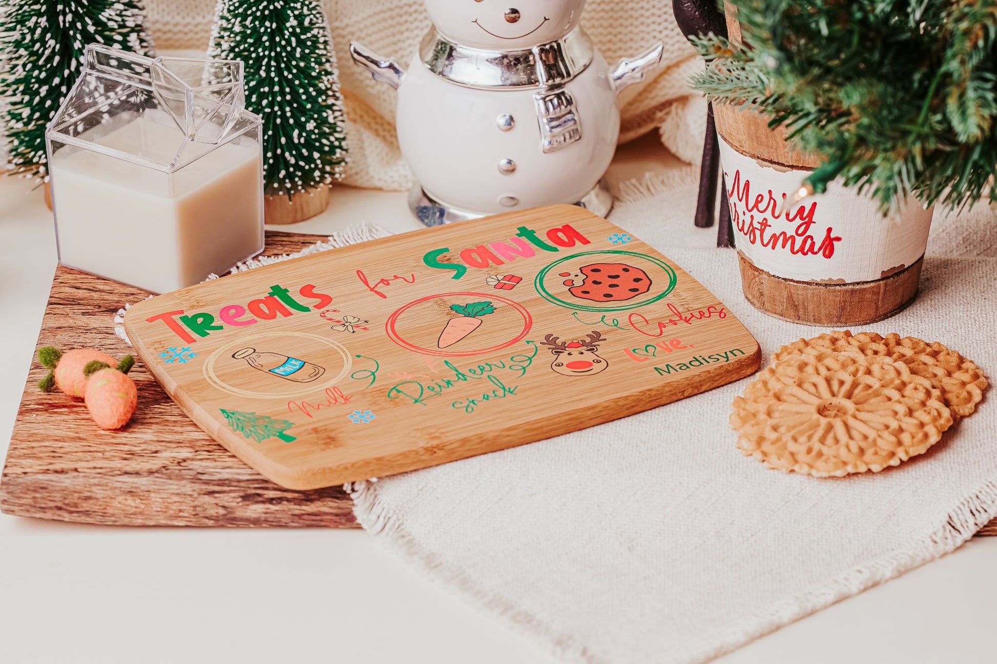 Create a festive Christmas Eve tradition with the Personalized Santa Treat Tray by Mirabilia Boutique—a custom bamboo board labeled for cookies, milk, and a carrot, perfect for setting out Santa’s treats beside your favorite holiday décor.