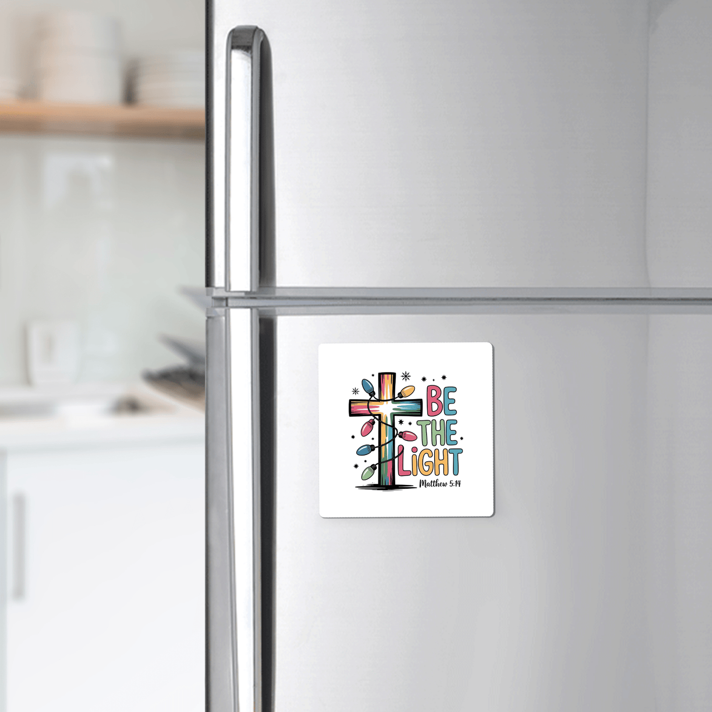The Be the Light Magnet by Mirabilia Boutique features a vibrant cross and Matthew 5:14—an uplifting Christian fridge decor, ideal as a faith-inspired gift or stocking stuffer for any modern kitchen.