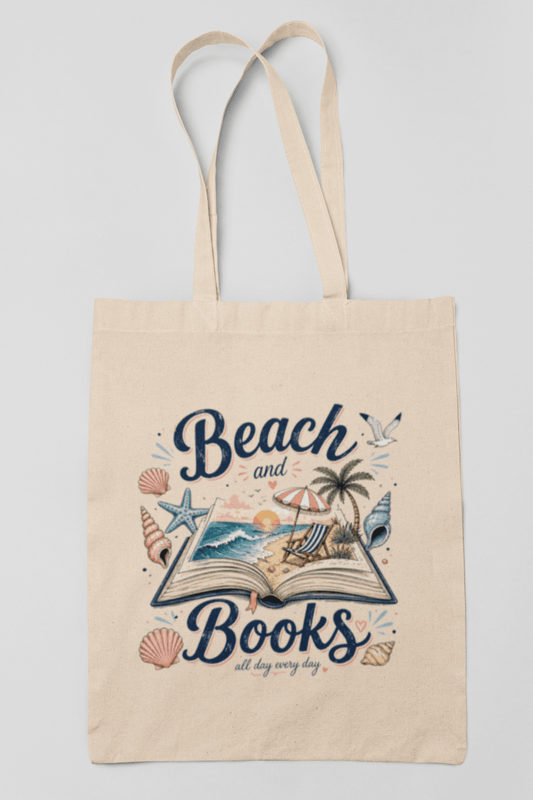 The Beach and Books Canvas Tote Bag by Mirabilia Boutique is a beige canvas bag featuring an open book with a beach scene—palm tree, seagull, starfish, and seashells. Perfect for anyone who loves books and the beach all day, every day.