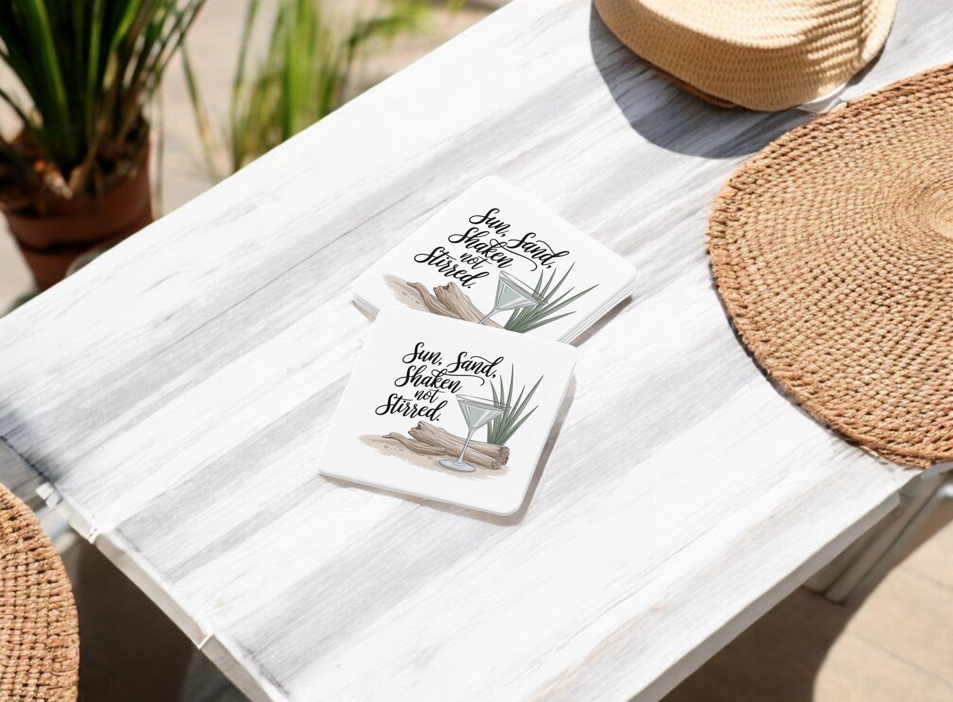 The Sun, Sand, Shaken Not Stirred Coastal Summer Vibe Coaster Set by Mirabilia Boutique includes two square coasters with palm leaf designs—ideal for your summer bar cart or as a stylish beach accent.