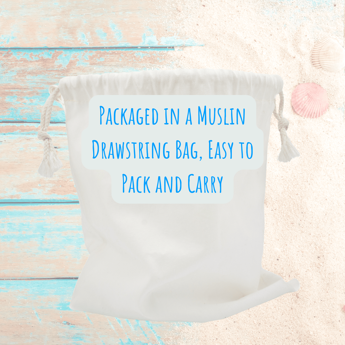 A white muslin drawstring bag with blue text sits on a beach backdrop—perfect for storing your Mirabilia Boutique Beach Match Game | 60 Tiles | Screen-Free Family Fun or other memory-boosting games.