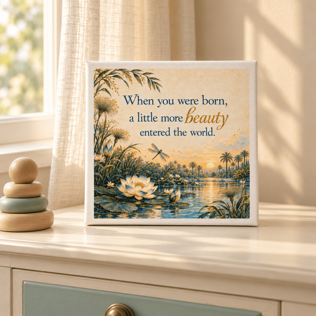 A Little More Beauty Canvas nursery print featuring a sunset lake scene with lotus flowers, a dragonfly, and the quote, “When you were born, a little more beauty entered the world.”