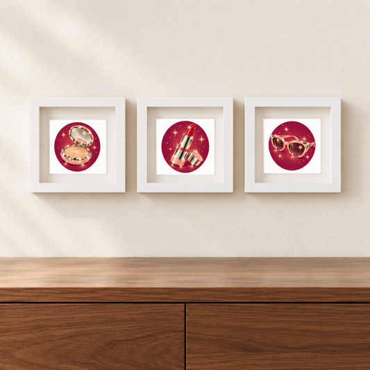 Three white-framed Beauty Rituals of Chrome & Starlight | Mirabilia Relics prints by Mirabilia Boutique hang on a beige wall above a wooden cabinet, each featuring bold red circles with beauty icons.