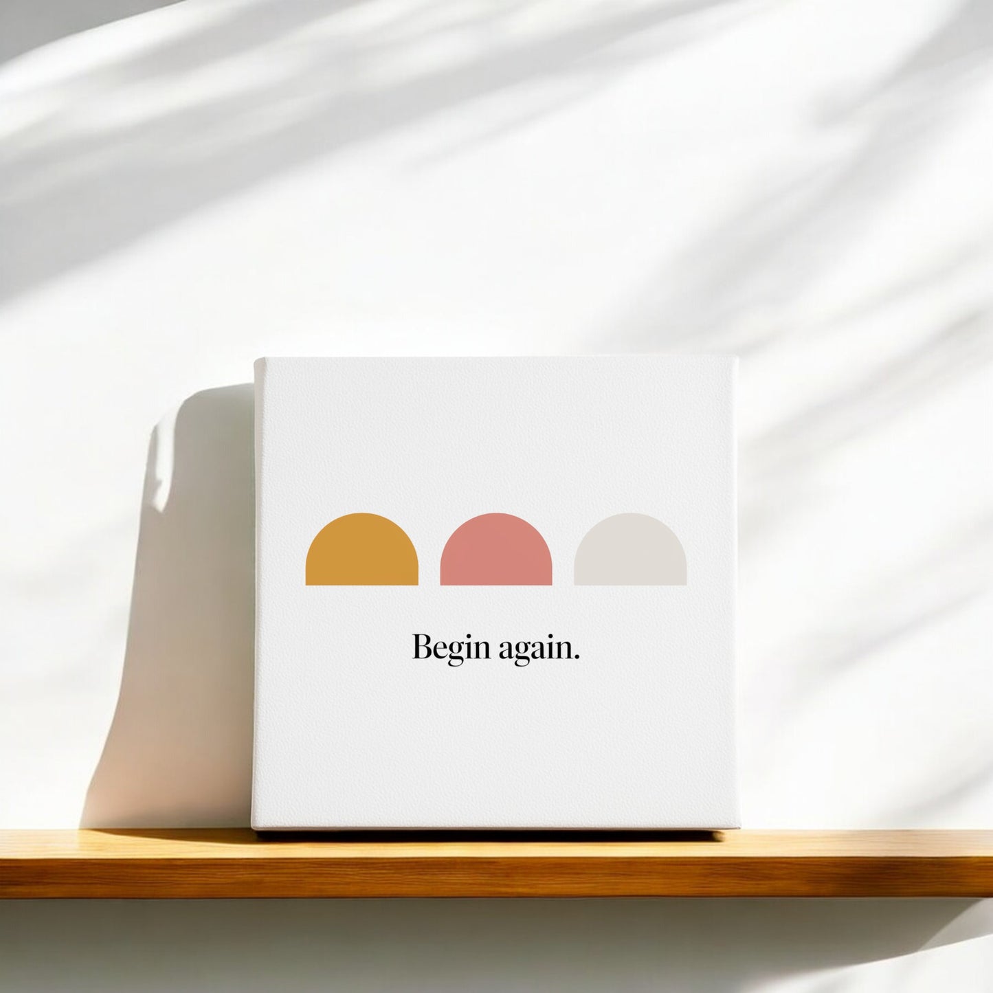 The Begin Again Canvas – Soft Summer Affirmation Wall Art by Mirabilia Boutique features three colorful semi-circles and "Begin again" text, making it perfect sunrise decor for your space.