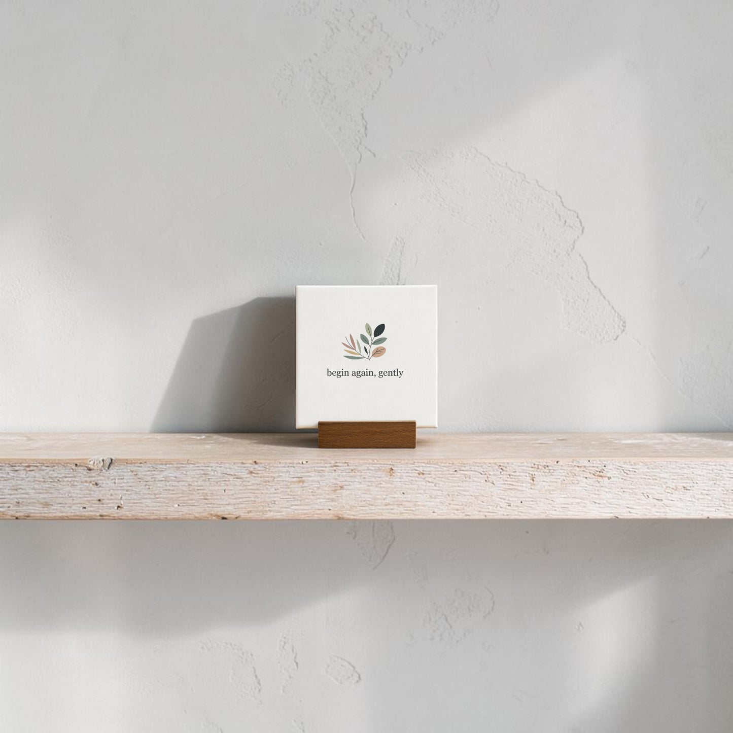 The Begin Again Gently Mini Sign with Wooden Stand by Mirabilia Boutique features minimalist art and a motivational message, making it ideal botanical desk decor for your shelf or workspace.