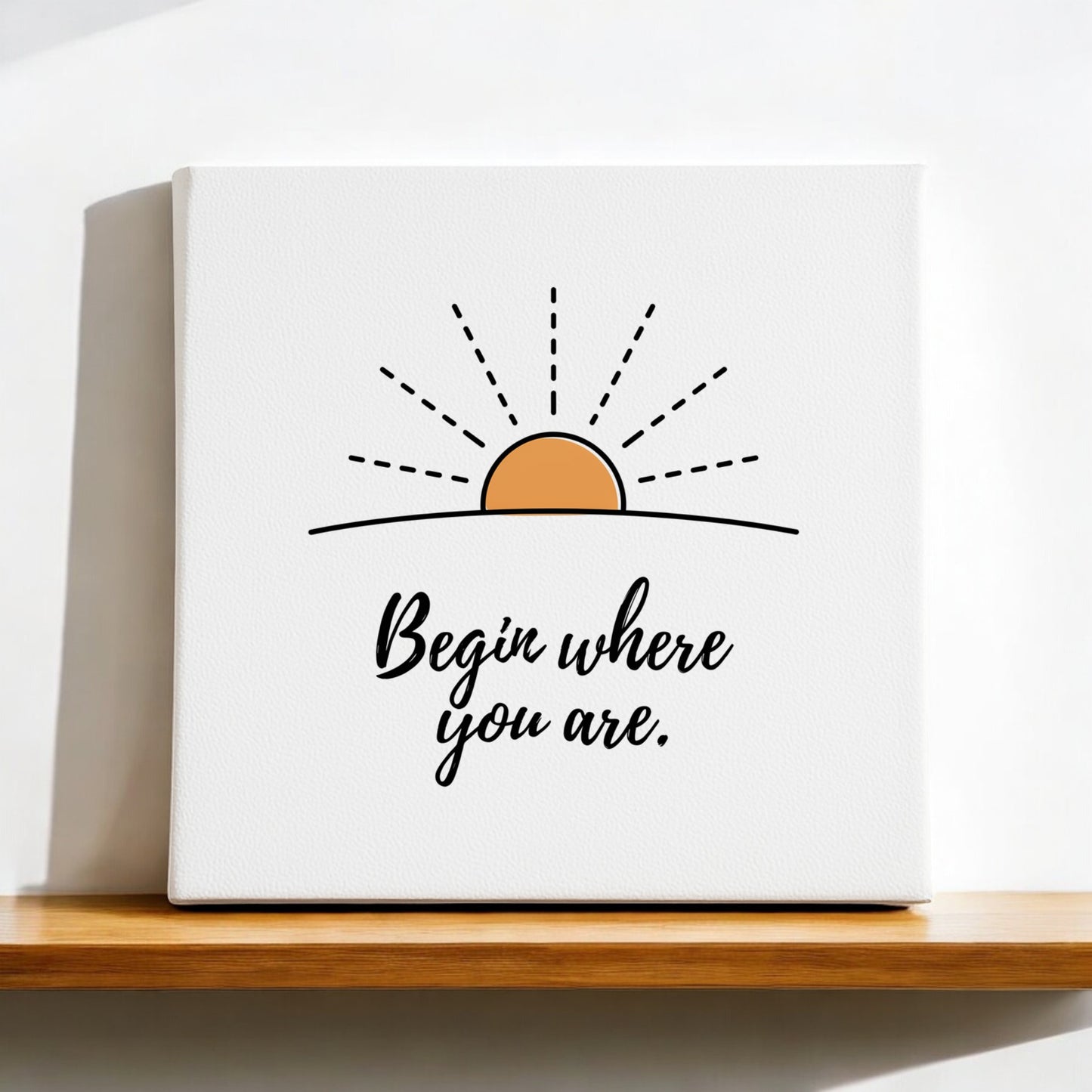 The Begin Where You Are Canvas – Sunrise Wall Affirmation by Mirabilia Boutique displays a minimalist sunrise and the phrase "Begin where you are." in black cursive, making calming wall art for any space.