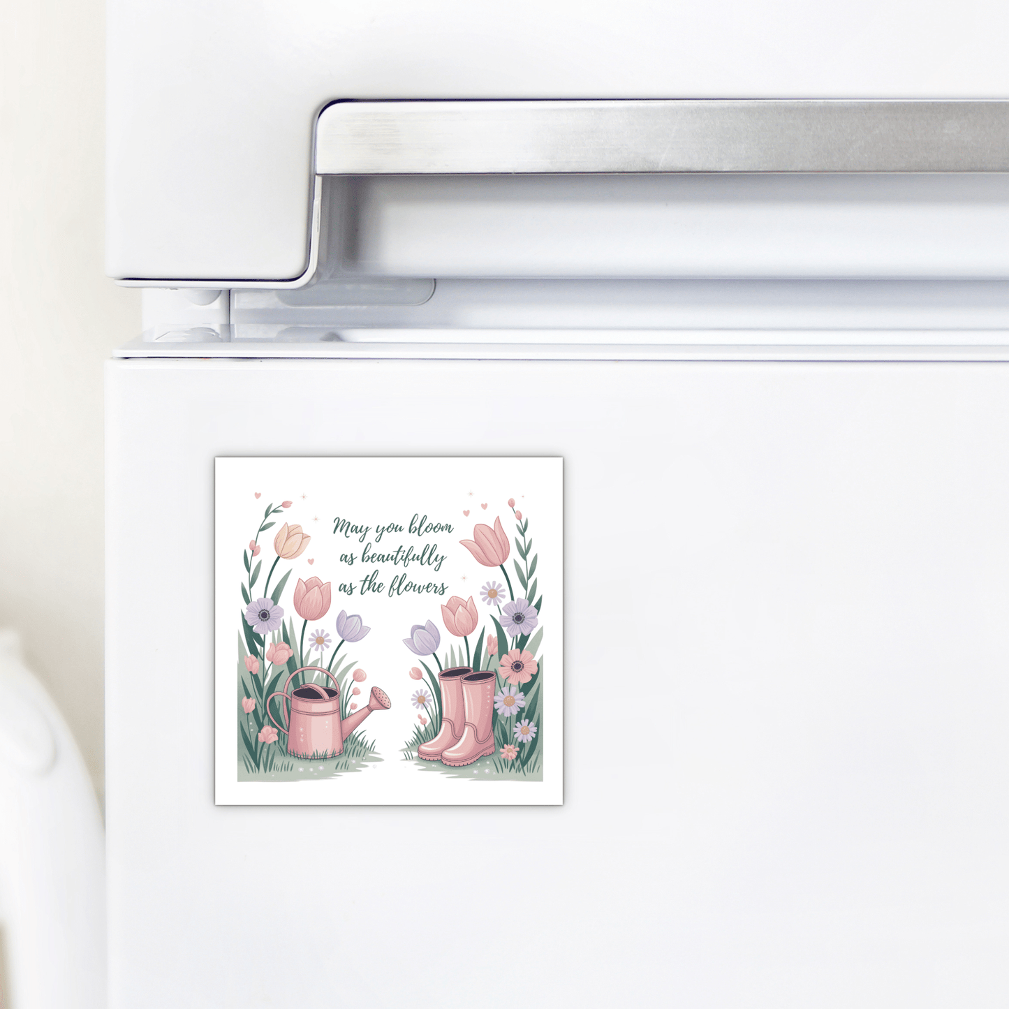 The Bloom Like the Flowers Magnet – Spring Floral Quote by Mirabilia Boutique features rain boots, a watering can, tulips, and the message, "May you bloom as beautifully as the flowers." A charming encouragement gift for any space.