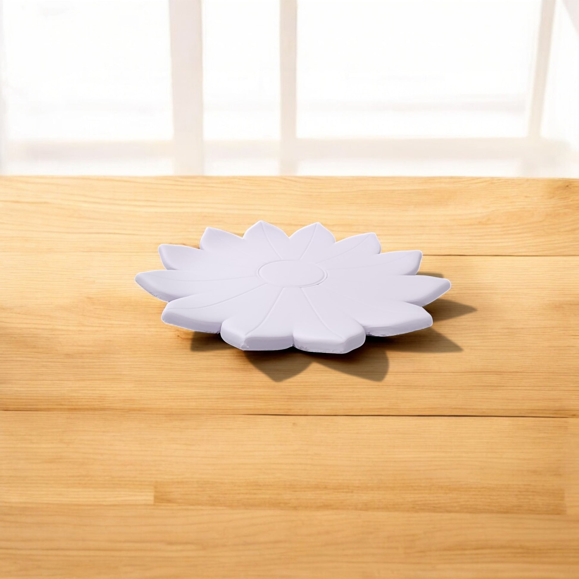 The Spring Bloom Tray by Mirabilia Boutique, a delicate floral accent in white, sits on a light wooden surface with sunlight streaming through a nearby window.
