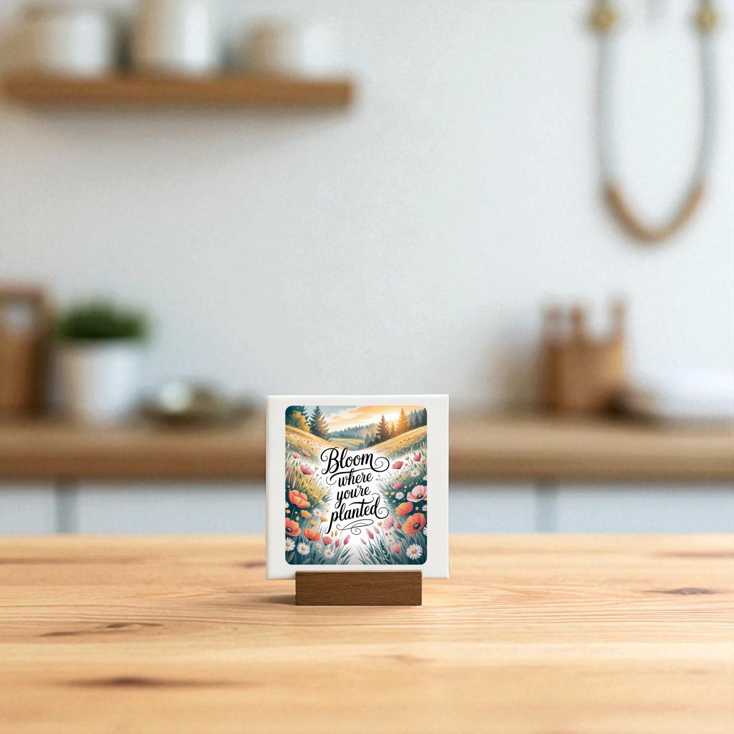 The Bloom Where You’re Planted Canvas | Mini Wildflower Art by Mirabilia Boutique stands on a wooden base, displaying its uplifting message and colorful blooms—perfect for adding cheerful charm to any kitchen counter.
