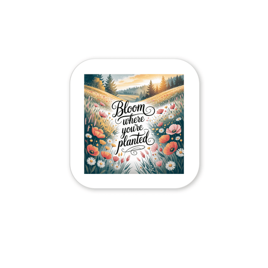 The Bloom Where You’re Planted Magnet by Mirabilia Boutique features a sunrise meadow with daisies and poppies, rolling hills, and the quote “Bloom where you’re planted”—a perfect uplifting floral accent for your space.