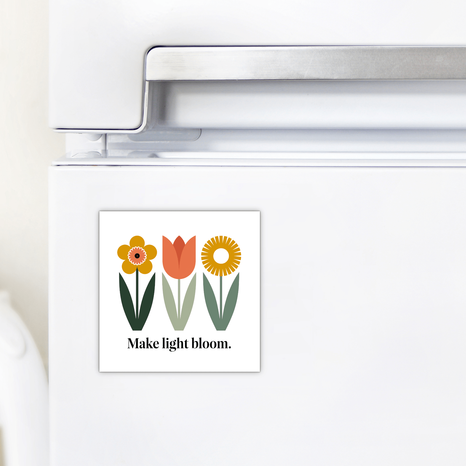 Add cheerful spring decor with the Make Light Bloom Magnet – Spring Floral Inspiration by Mirabilia Boutique, a square floral fridge magnet featuring three simple flowers and the words "Make light bloom.