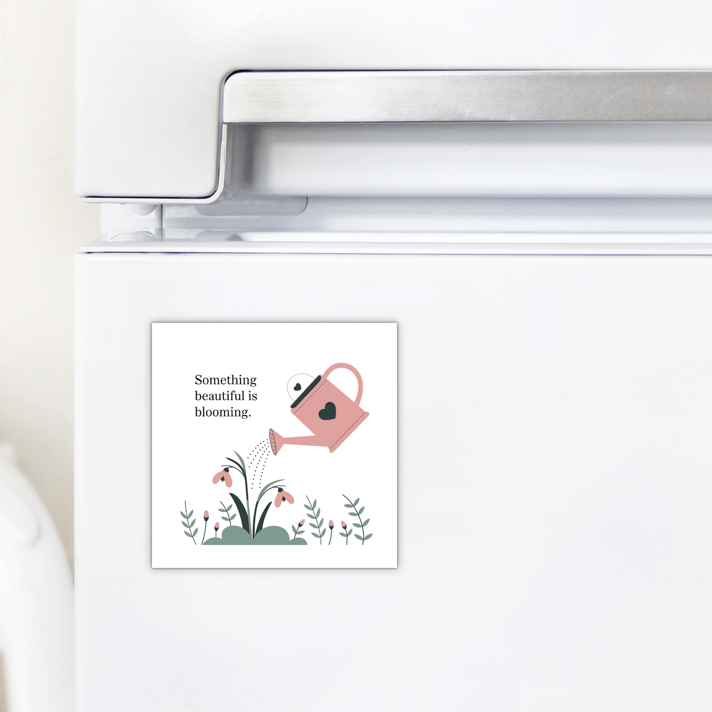 The “Something Beautiful Is Blooming Magnet” by Mirabilia Boutique features a pink watering can with flowers and a heart—an uplifting, growth-inspired fridge decor perfect as a mental health reminder or self-care gift.